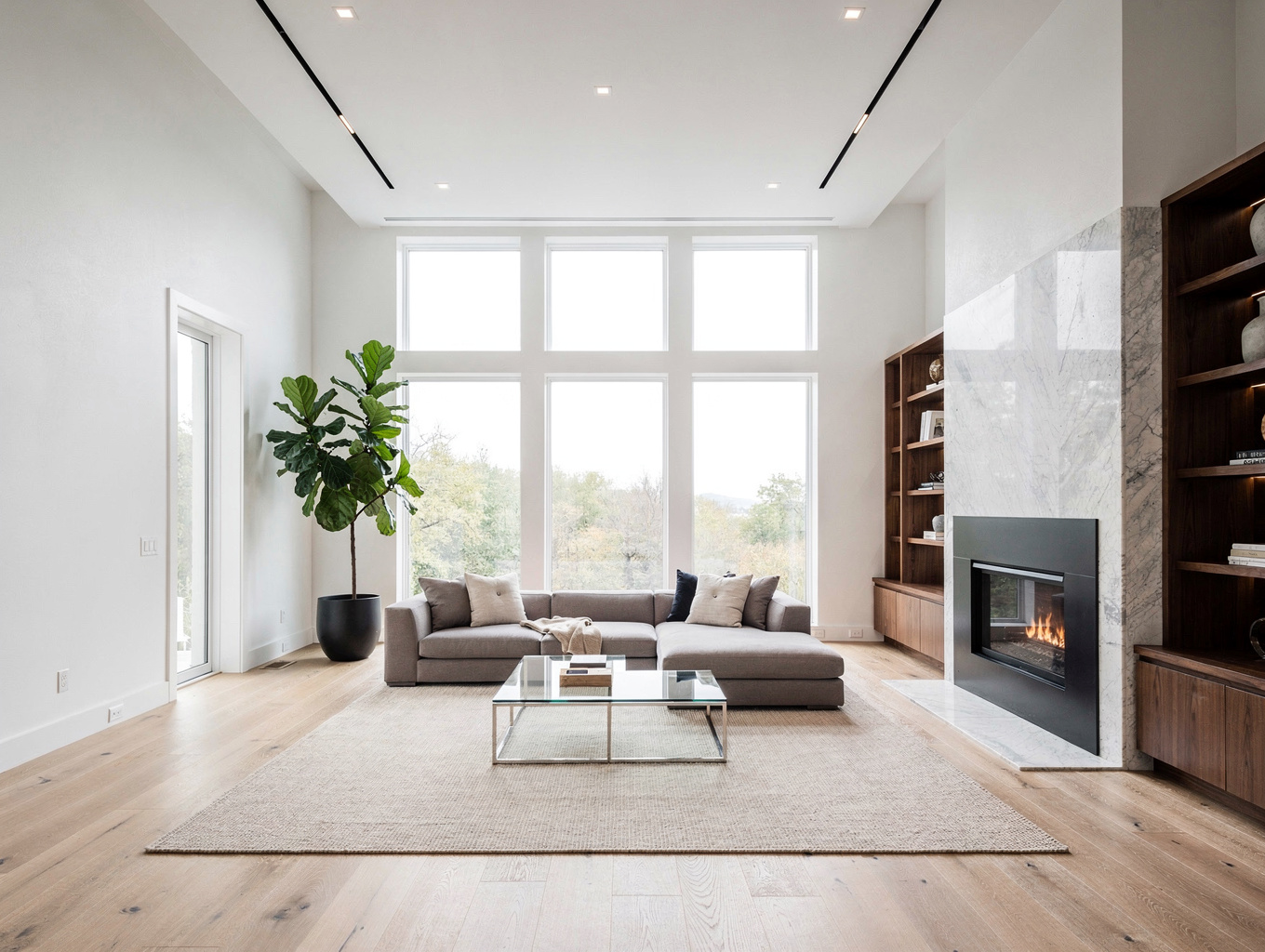 Open-concept living room renovation in Acworth featuring warm wood beams and modern fireplace